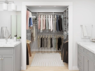Modern walk-in closet with organized wardrobe and shelves.