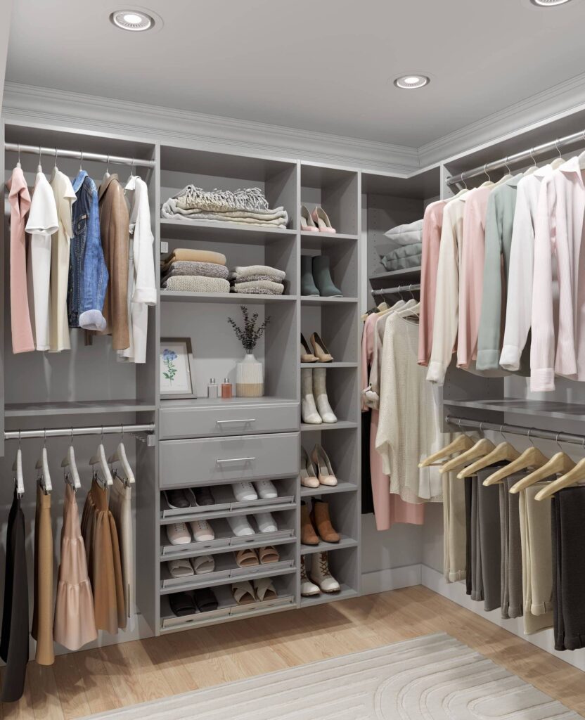 Organized walk-in closet with clothes and shoes.