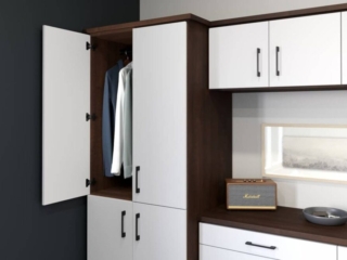 White wardrobe with clothes and shelf with speaker
