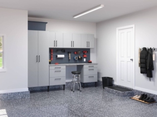 Organized garage with cabinets and workbench.
