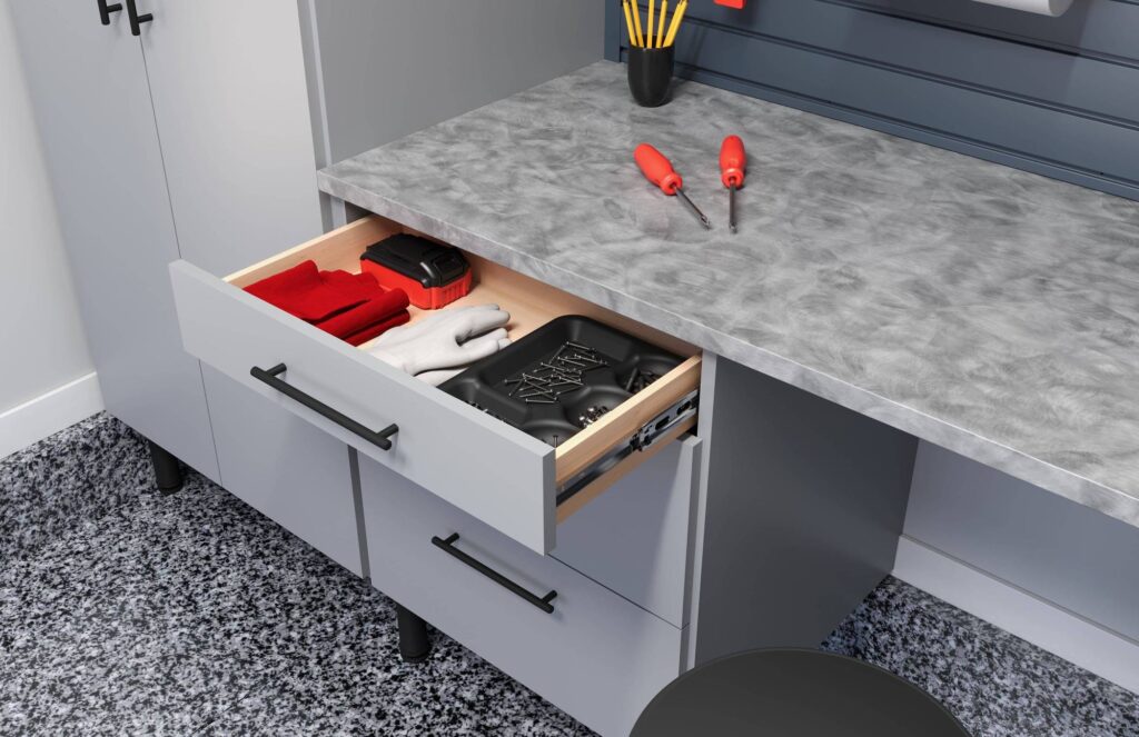 Open workbench drawer with tools and gloves