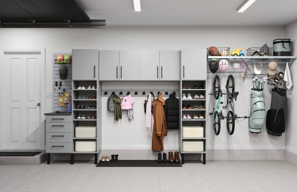 Organized garage with cabinets, hooks, and sports equipment.