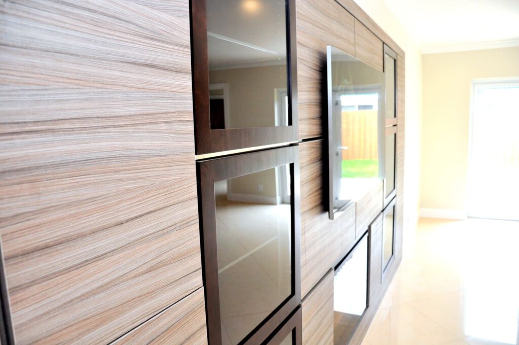 Wood-paneled wall with built-in flat screens