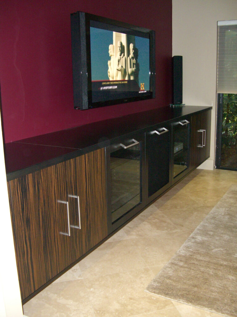 Mounted TV above modern cabinet in living room.