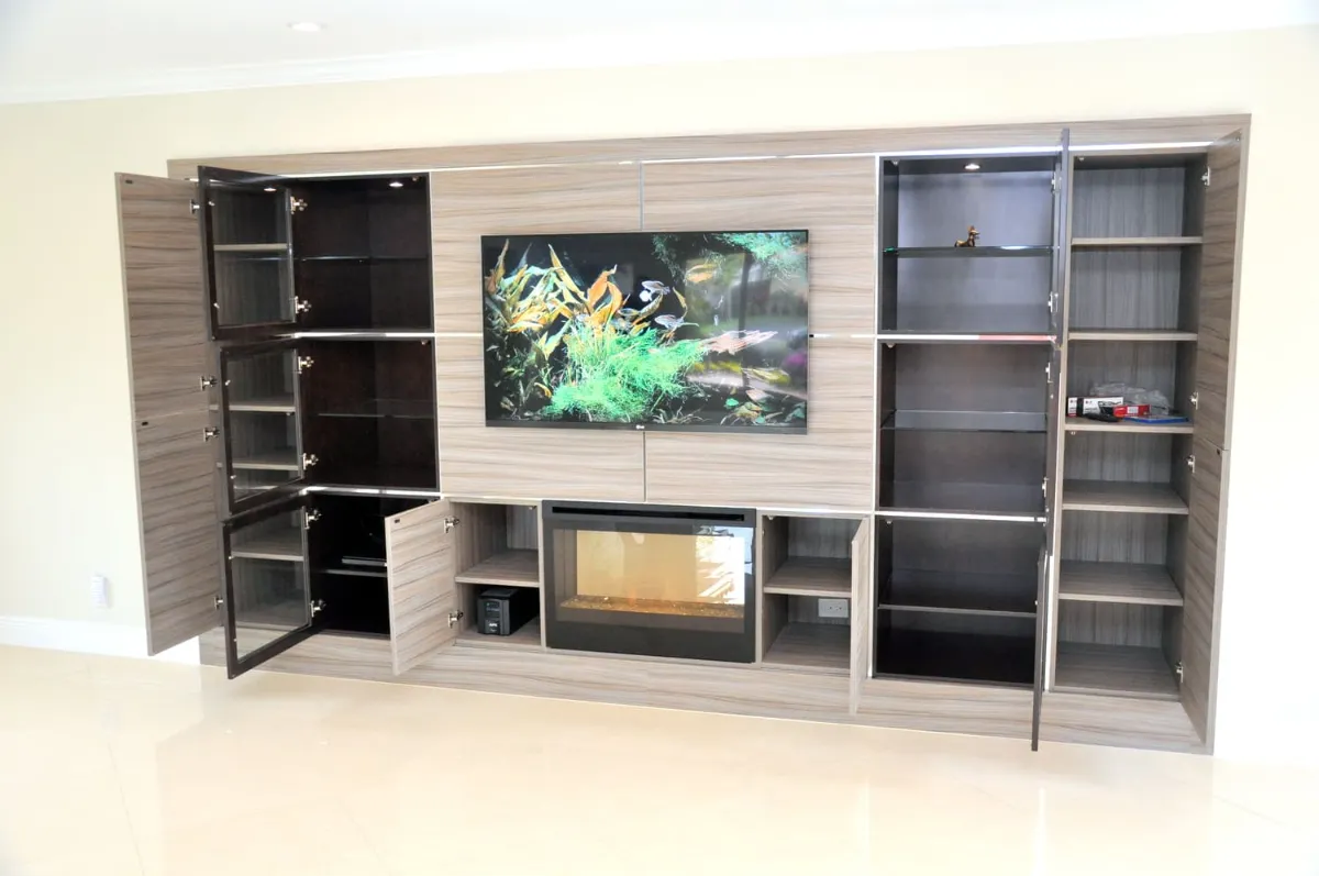 Wall unit with a TV, linear fireplace and glass-door display cabinets